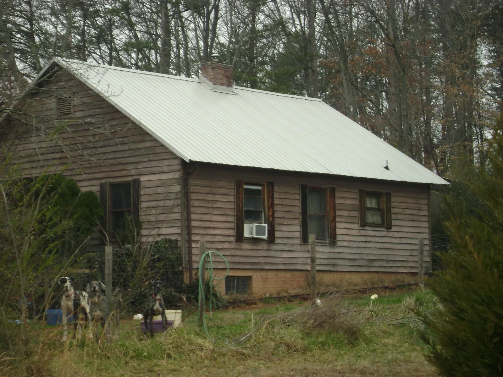 White metal roof on an old wood sided farmhouse, from a Asphalt Shingle Roof Repair job in Shartlesville